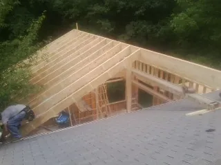 Framing a new roof addition that ties into an existing shingle roof in Blackstone